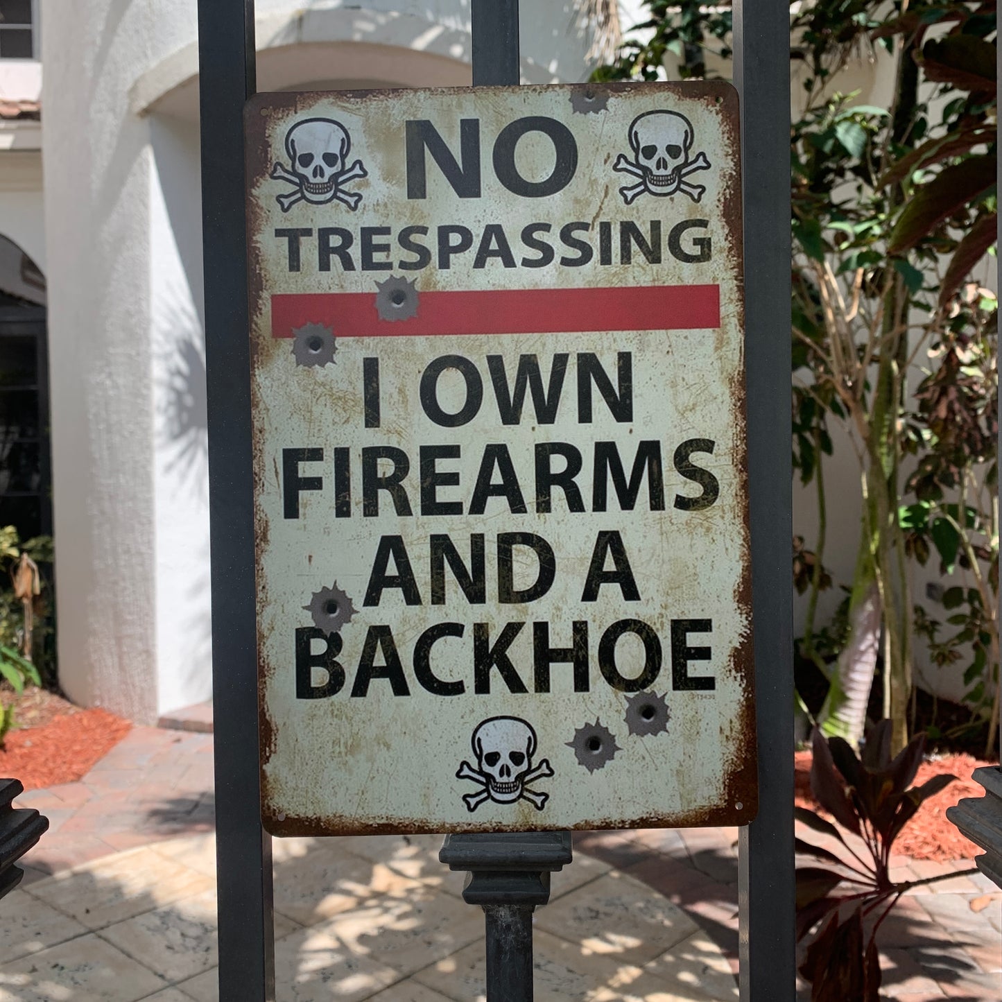 No Trespassing Warning Sign – “I Own Firearms & a Backhoe” Vintage Metal Wall Art for Home, Garage, or Farm Decor